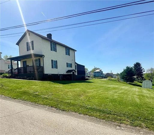 a view of a house with a backyard