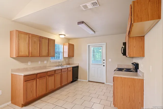 a kitchen with a sink and cabinets