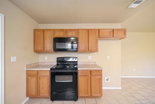 a kitchen with stainless steel appliances a stove microwave and sink