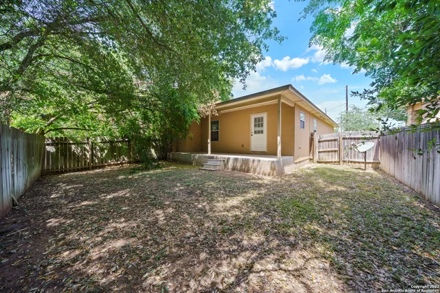 a backyard of a house with shaded area