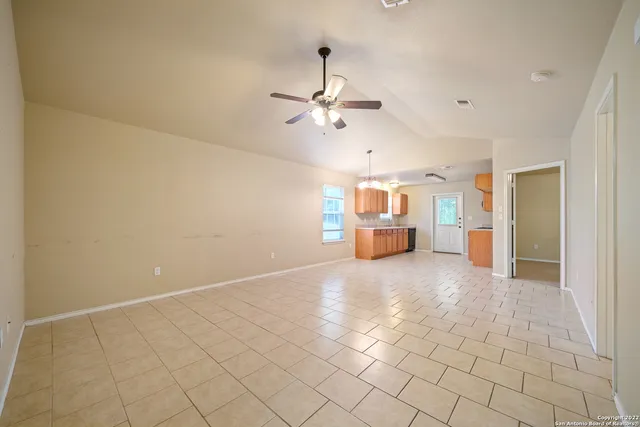 a view of a kitchen with furniture and a ceiling fan