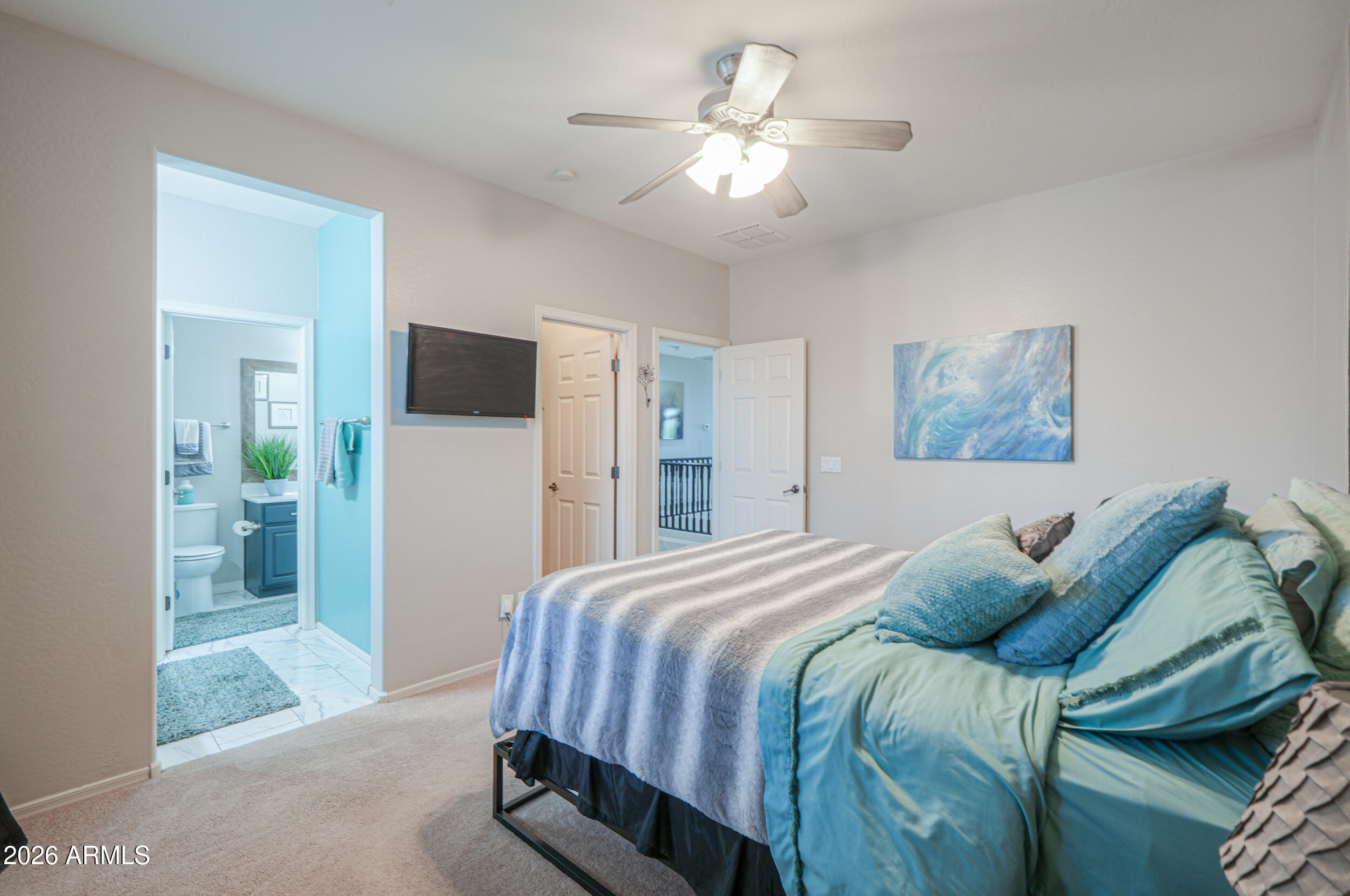 45247 West Jack Rabbit Trail Maricopa, AZ 85139 - Photo 35 of 75 a spacious bedroom with a bed and a chandelier