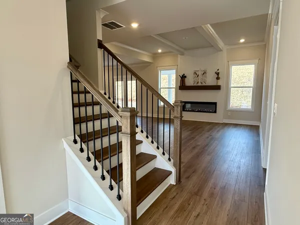 a bathroom with a glass shower door and a window