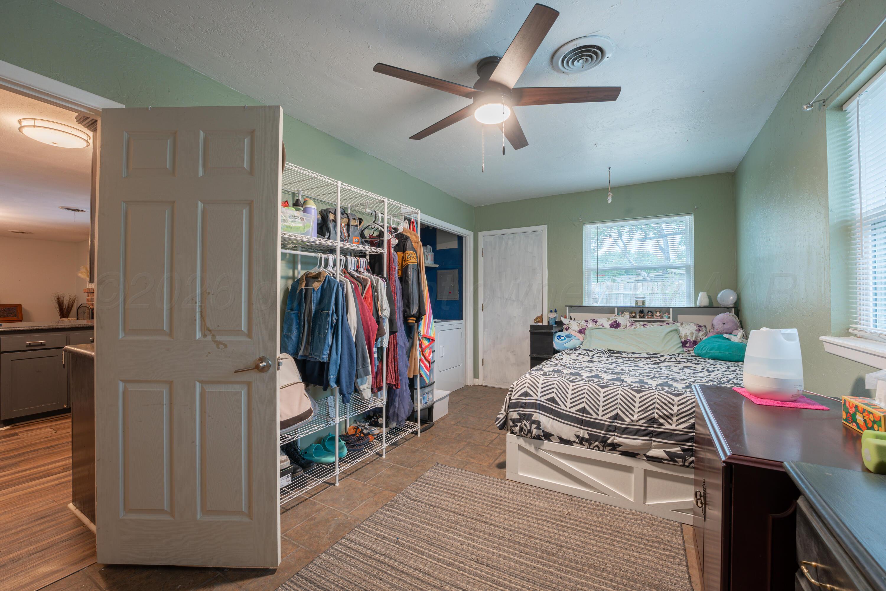 4836 Hillside Road Amarillo, TX 79109 - Photo 12 of 28 a bedroom with a bed and a walk in closet