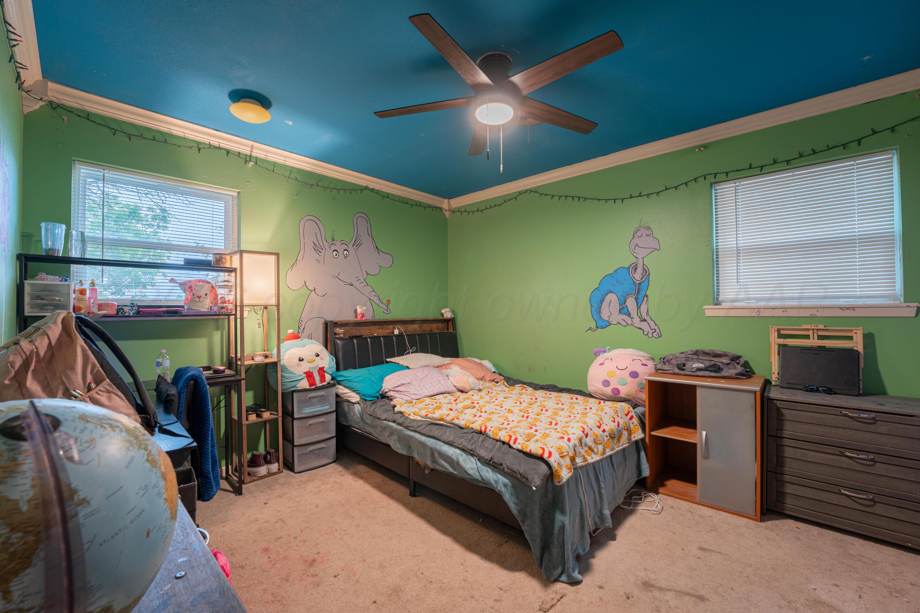 4836 Hillside Road Amarillo, TX 79109 - Photo 19 of 28 a bedroom with a bed and wooden floor