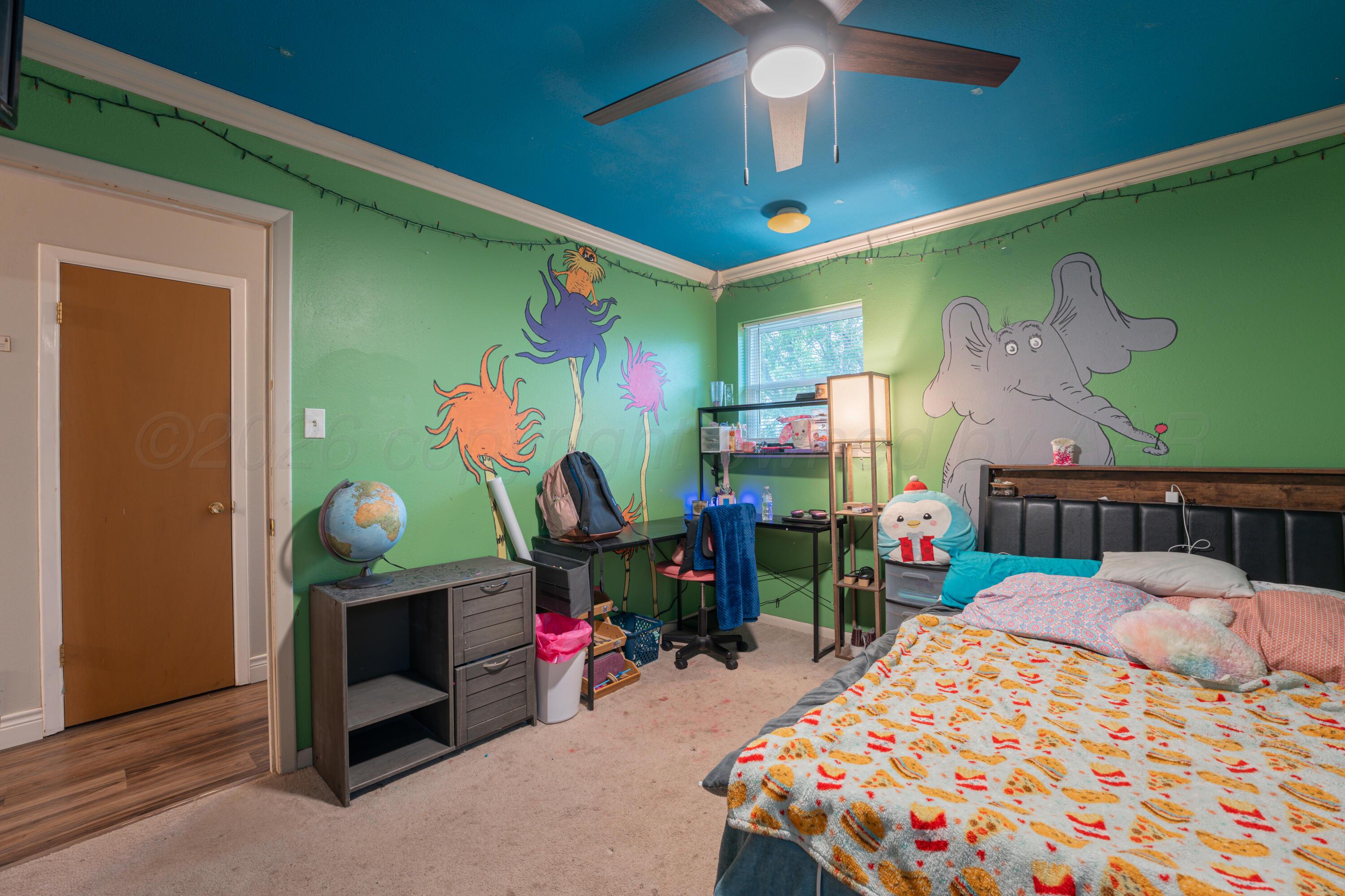 4836 Hillside Road Amarillo, TX 79109 - Photo 20 of 28 a bedroom with bed and a table