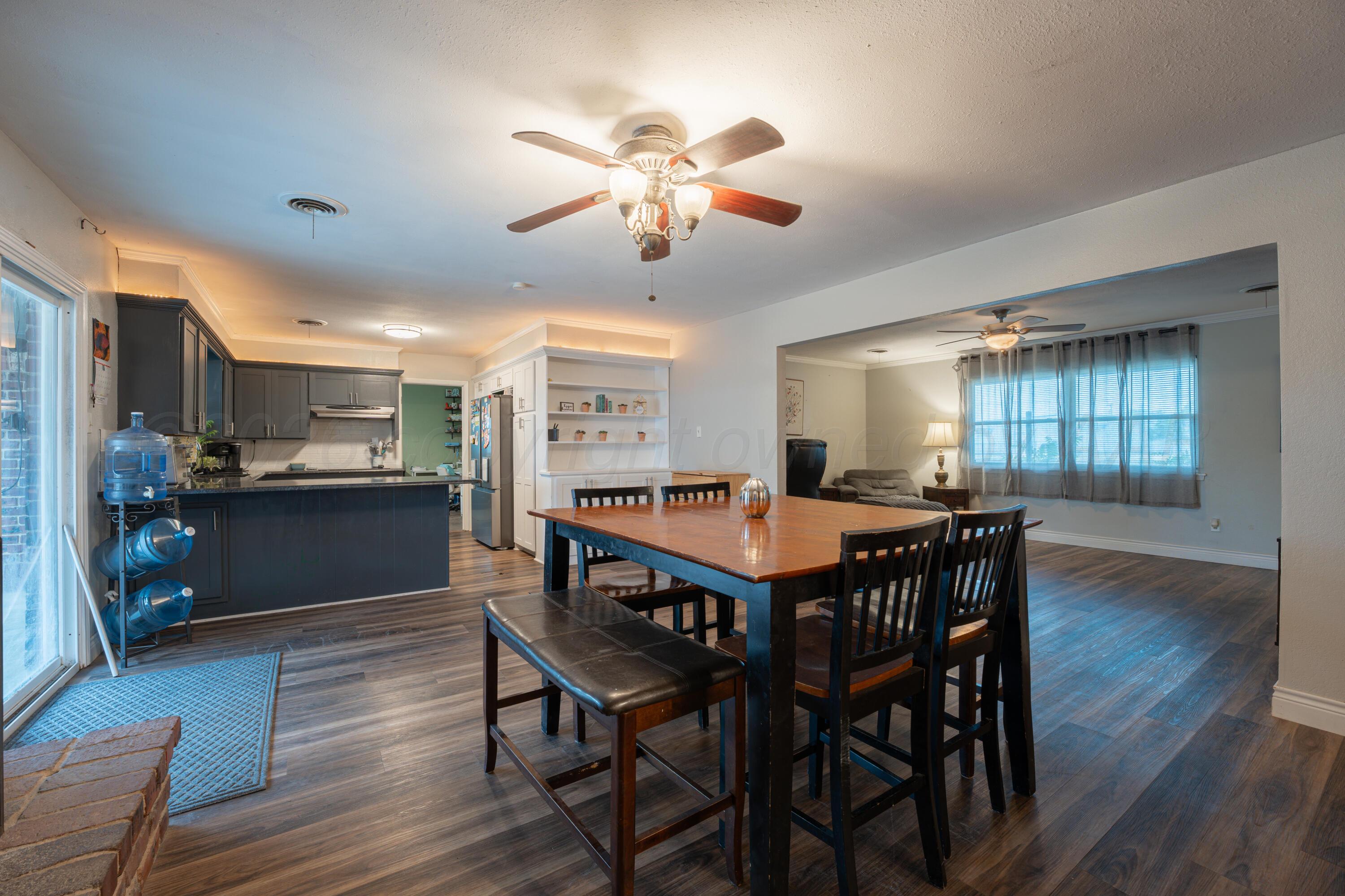 4836 Hillside Road Amarillo, TX 79109 - Photo 8 of 28 a dining room with furniture a rug and wooden floor