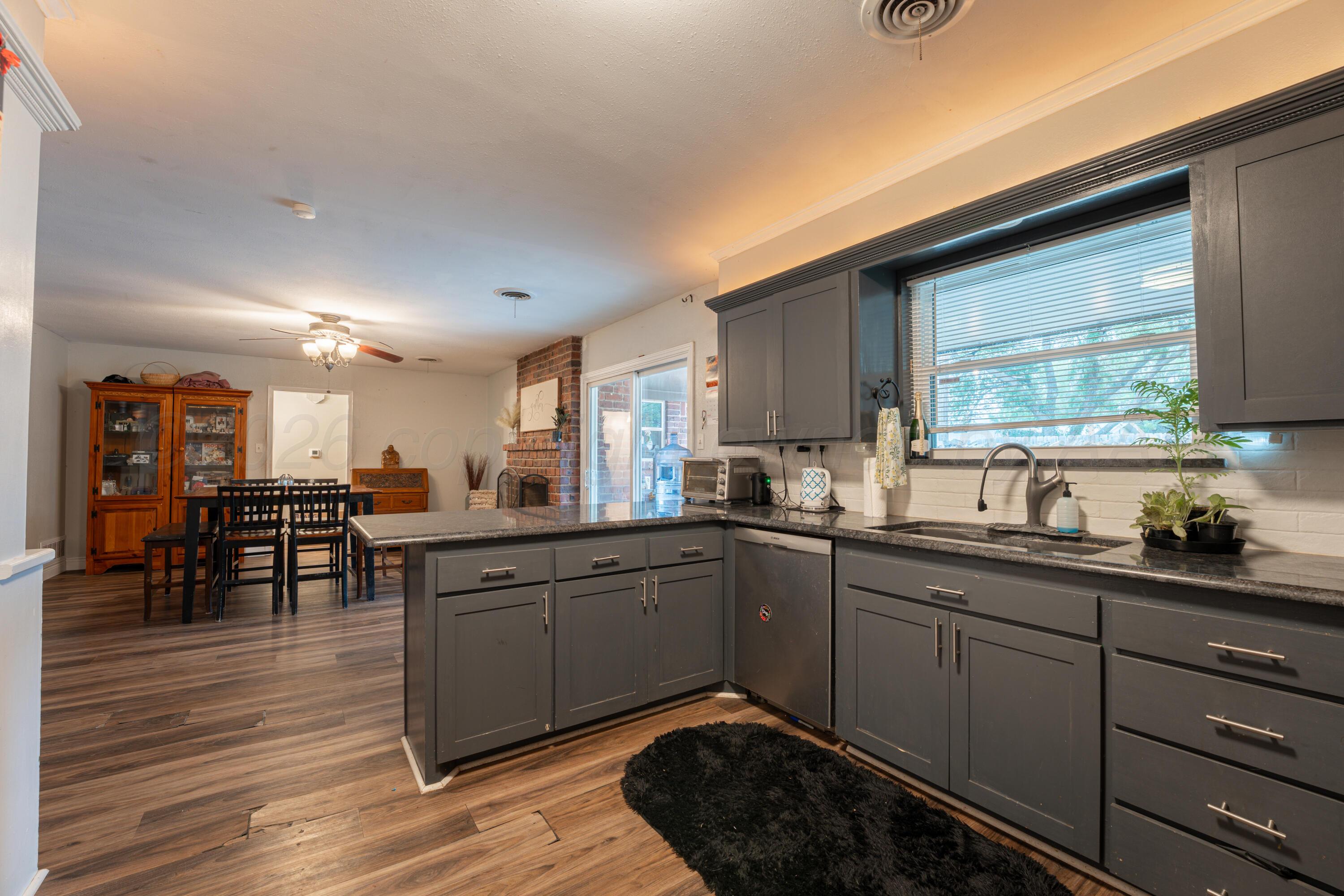 4836 Hillside Road Amarillo, TX 79109 - Photo 10 of 28 a kitchen with sink and cabinets