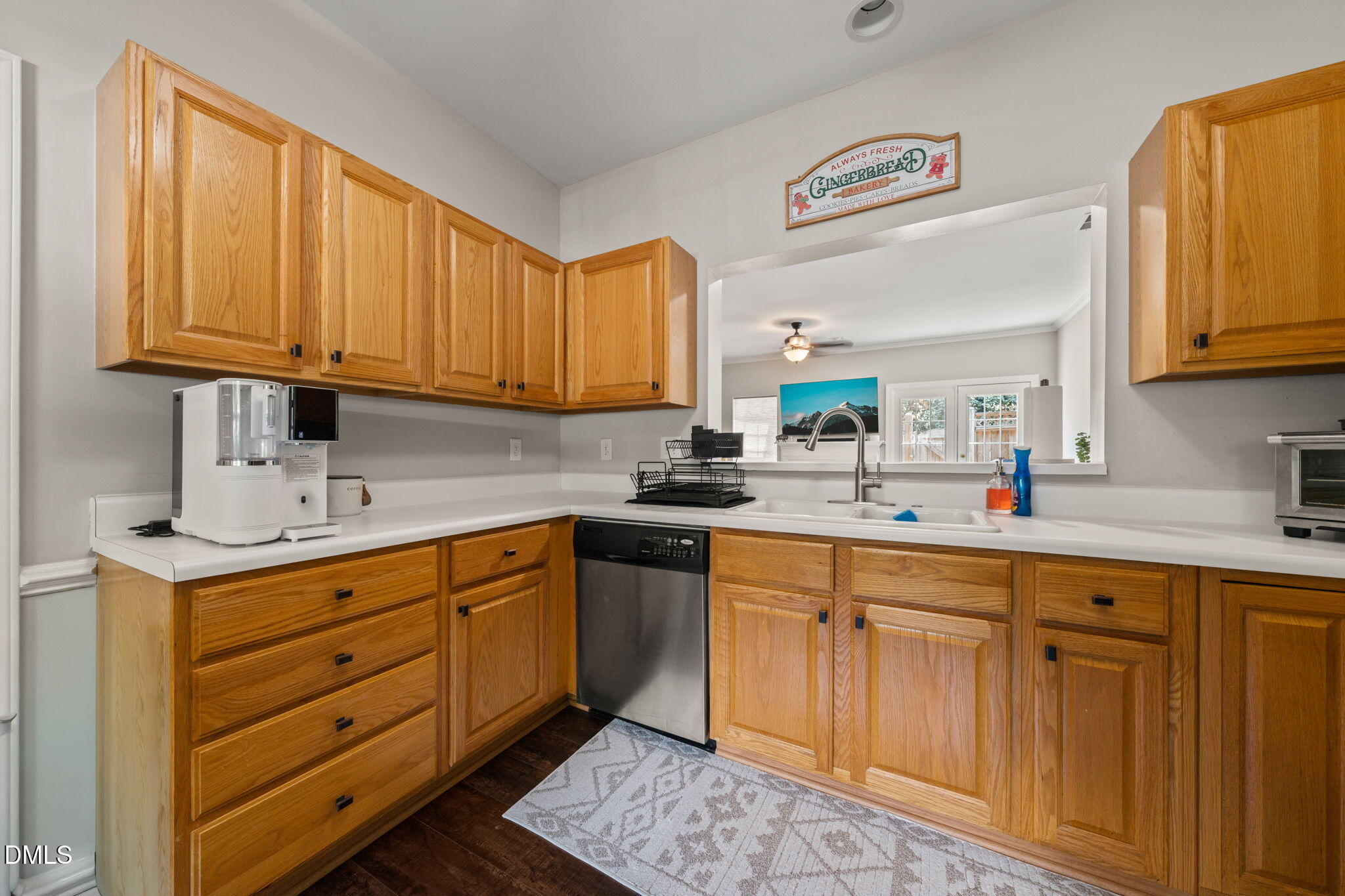 4323 Pine Springs Court Raleigh, NC 27613 - Photo 5 of 38 a kitchen with granite countertop wooden cabinets stainless steel appliances a sink and a window