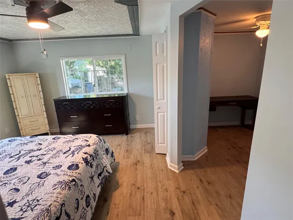 a bedroom with a bed and a dresser