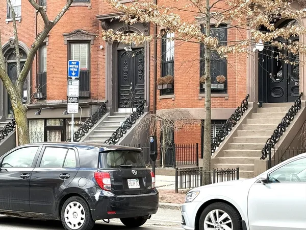 a front view of a house with parking space
