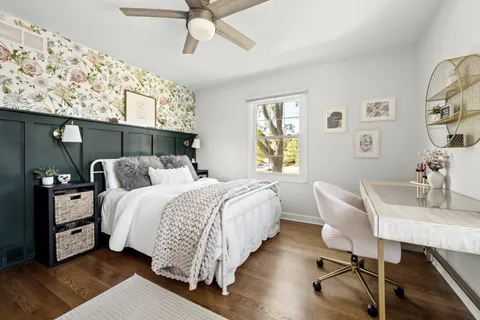 a bed room with a bed and a chair
