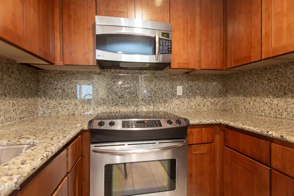 a kitchen with a stove and cabinets