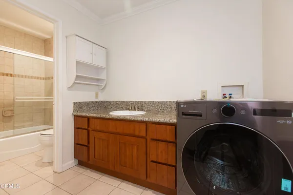 a utility room with sink dryer and washer