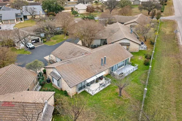 an aerial view of a house with swimming pool and sitting area