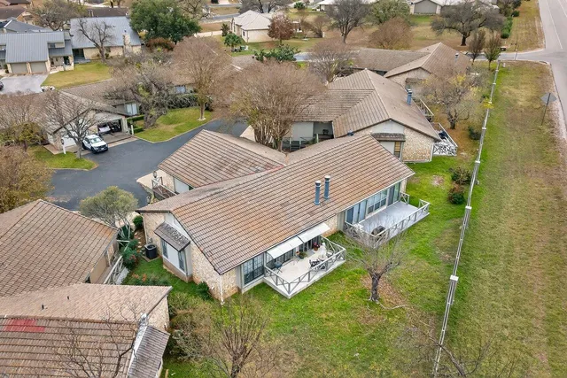 an aerial view of a house with swimming pool and sitting area