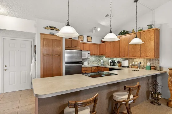 a kitchen with a table chairs and a chandelier