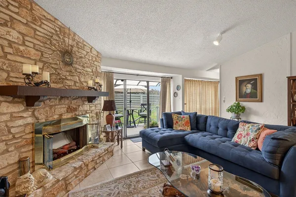a living room with furniture a flat screen tv and a fireplace