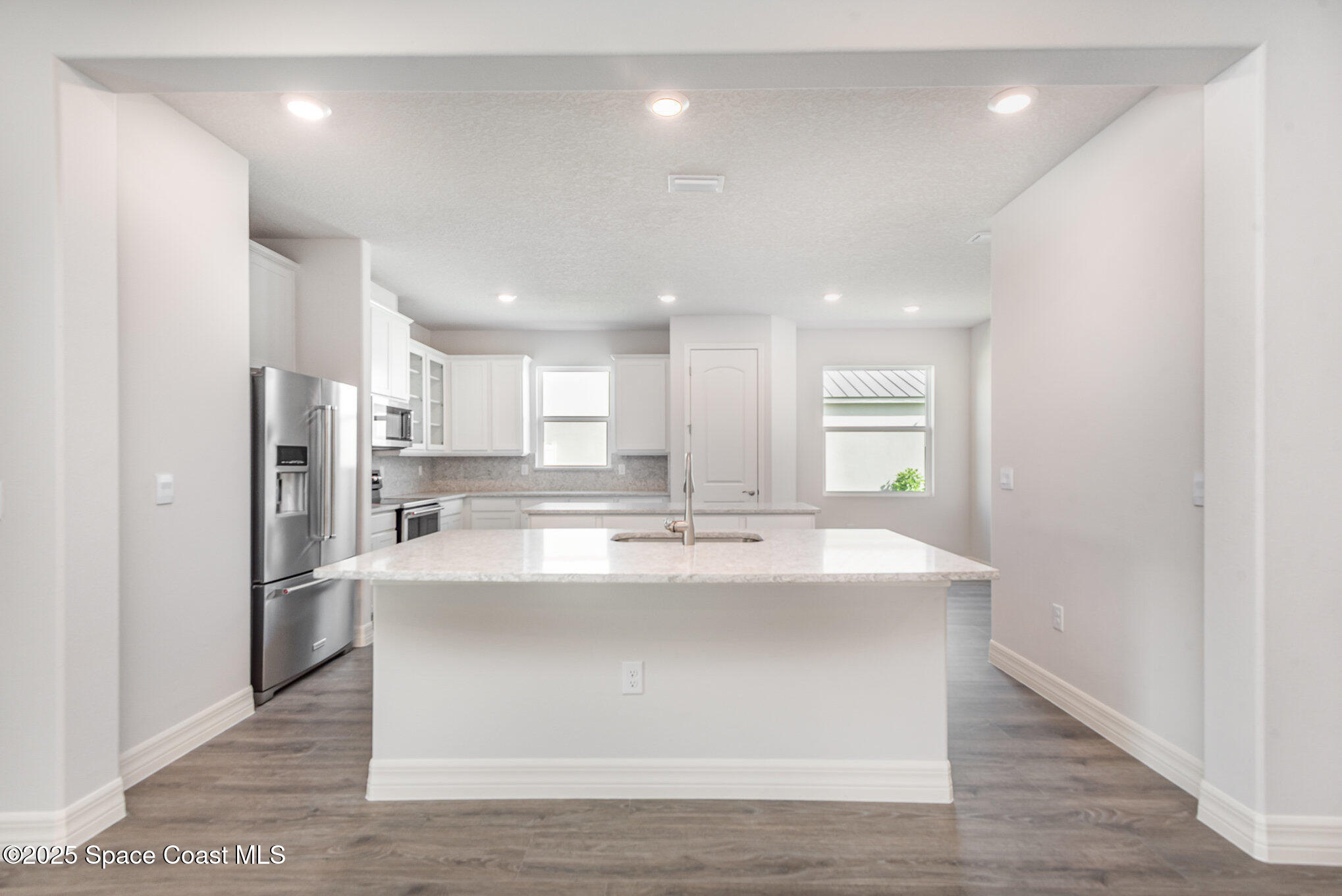 230 1st Street Cocoa, FL 32922 - Photo 11 of 34 a view of kitchen with kitchen island a sink wooden floor and refrigerator