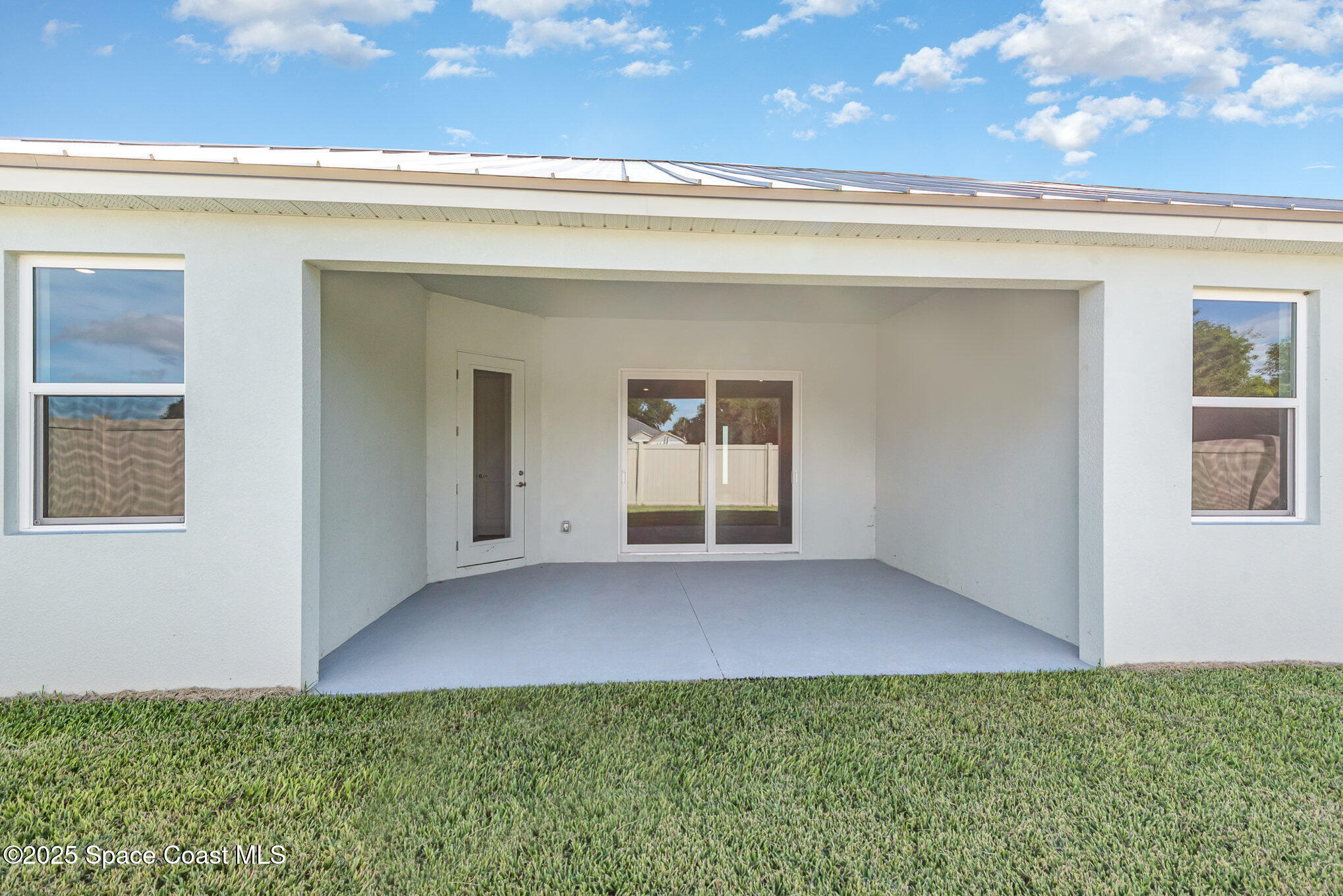 230 1st Street Cocoa, FL 32922 - Photo 22 of 34 a view of an empty room with chandelier fan and windows