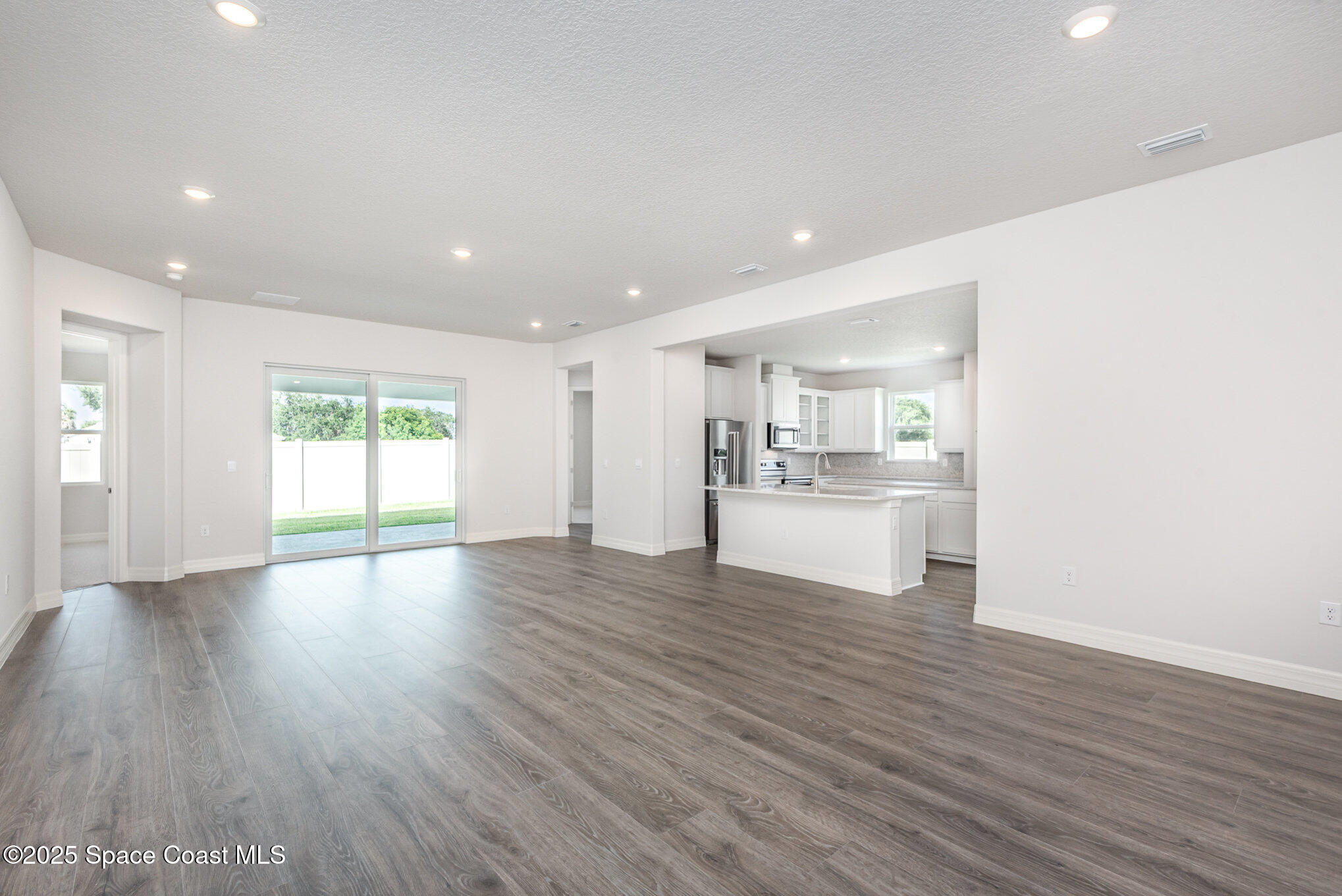 230 1st Street Cocoa, FL 32922 - Photo 7 of 34 a view of a kitchen with wooden floor and windows