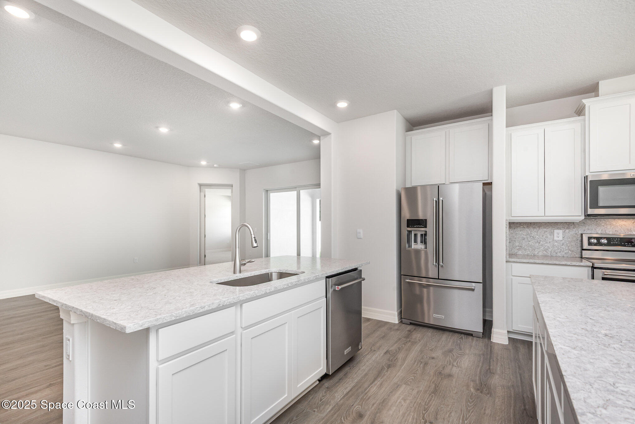 230 1st Street Cocoa, FL 32922 - Photo 10 of 34 a kitchen with a refrigerator and a sink