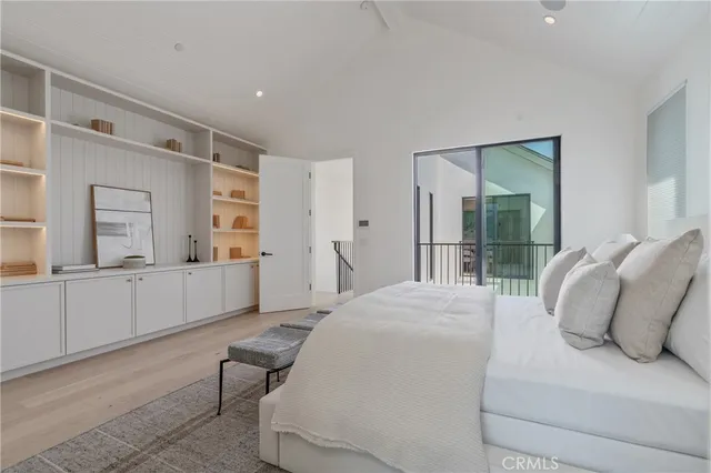 a bedroom with a bed and a large mirror