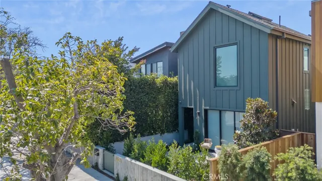a house with a flower garden in front of it
