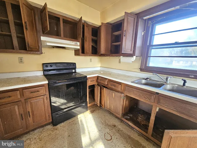 a kitchen with stainless steel appliances granite countertop a stove and a sink