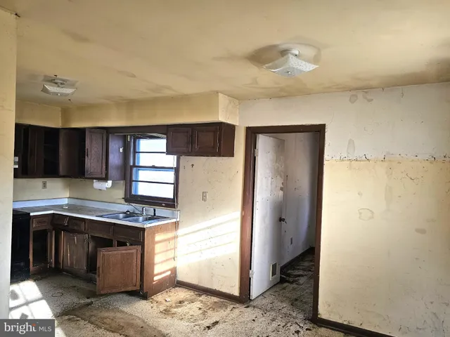 a kitchen with stainless steel appliances granite countertop a refrigerator and a stove