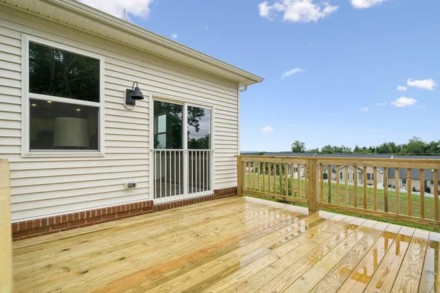 a view of a balcony with wooden floor