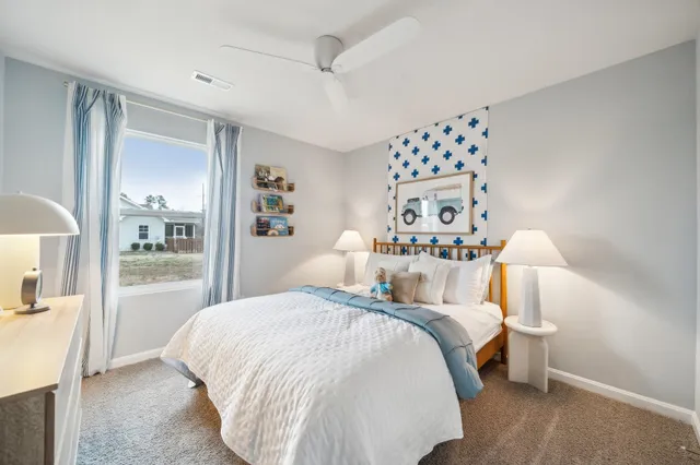 a bedroom with a large bed and a chandelier