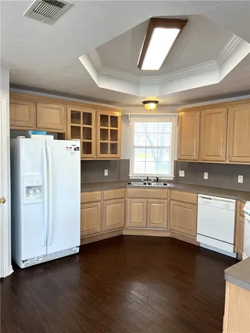 a kitchen with granite countertop white cabinets and white appliances
