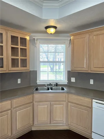 a kitchen with granite countertop white cabinets and a window
