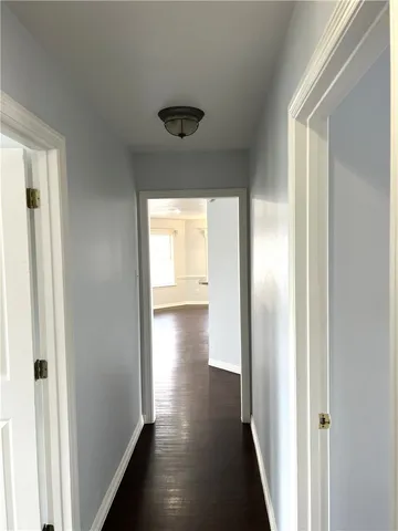 a view of hallway with wooden floor