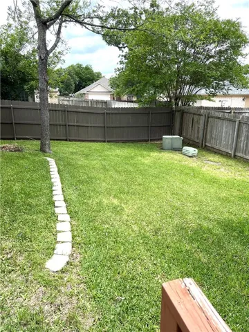 an empty room with wooden floor and a window