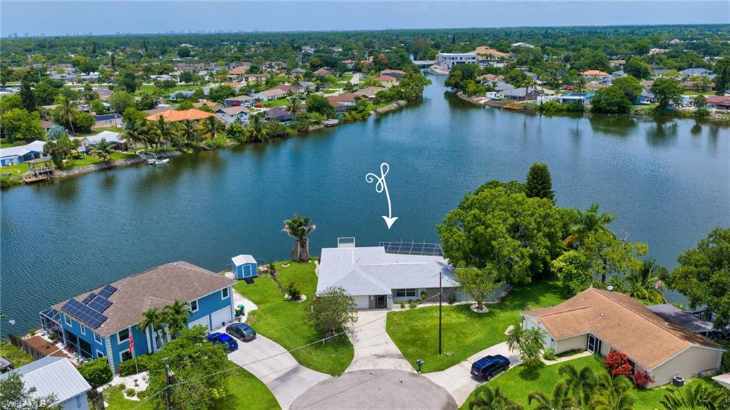 3065 50th Lane Southwest Naples, FL 34116 - Photo 1 of 31 an aerial view of lake residential house with outdoor space