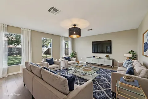 a living room with furniture and a flat screen tv