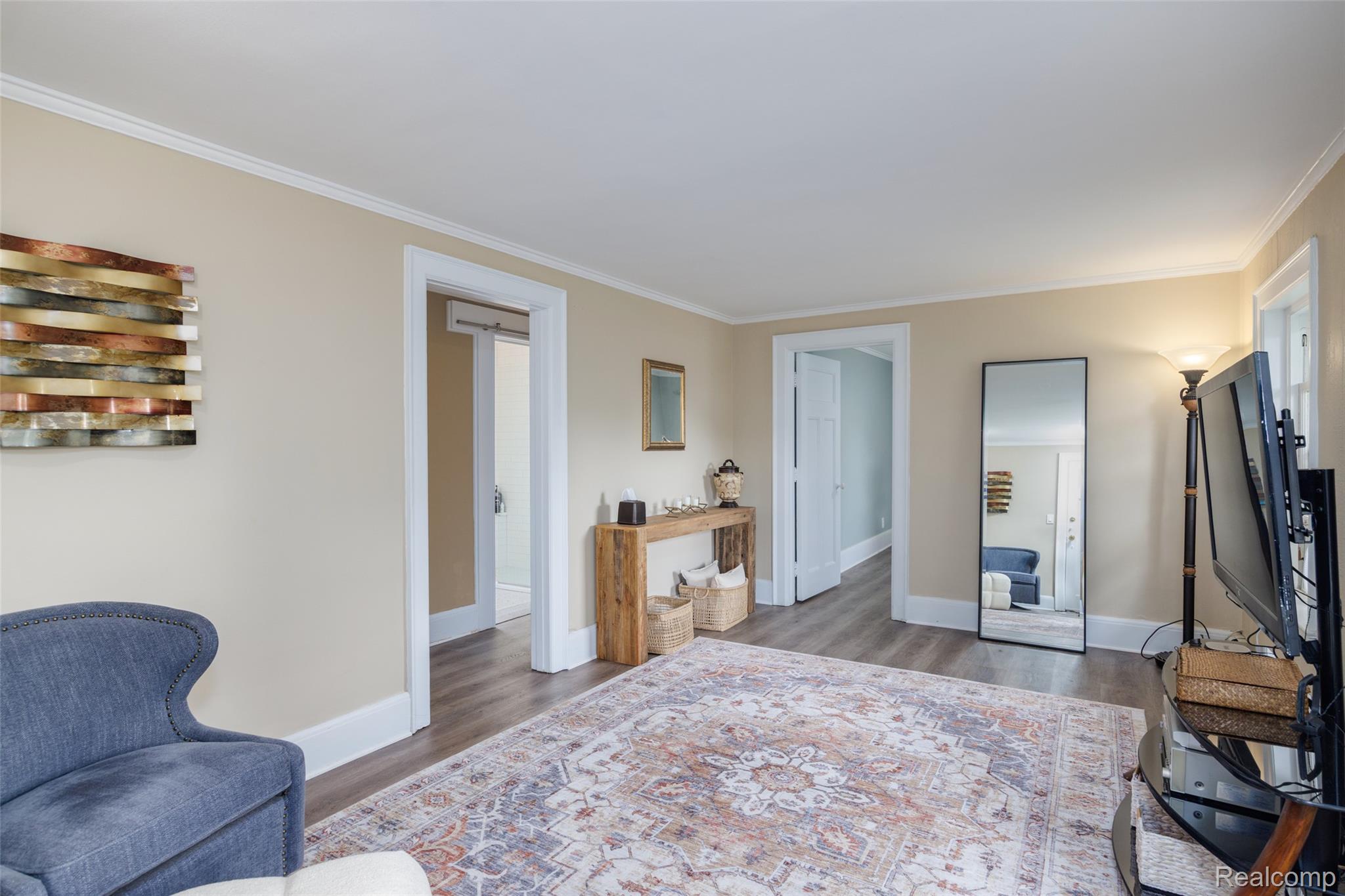 189 Cloverly Road Grosse Pointe, MI 48236 - Photo 69 of 93 Beyond the breezeway, the carriage house begins with a comfortable living room, offering a private and versatile space for guests, extended family, or independent living.