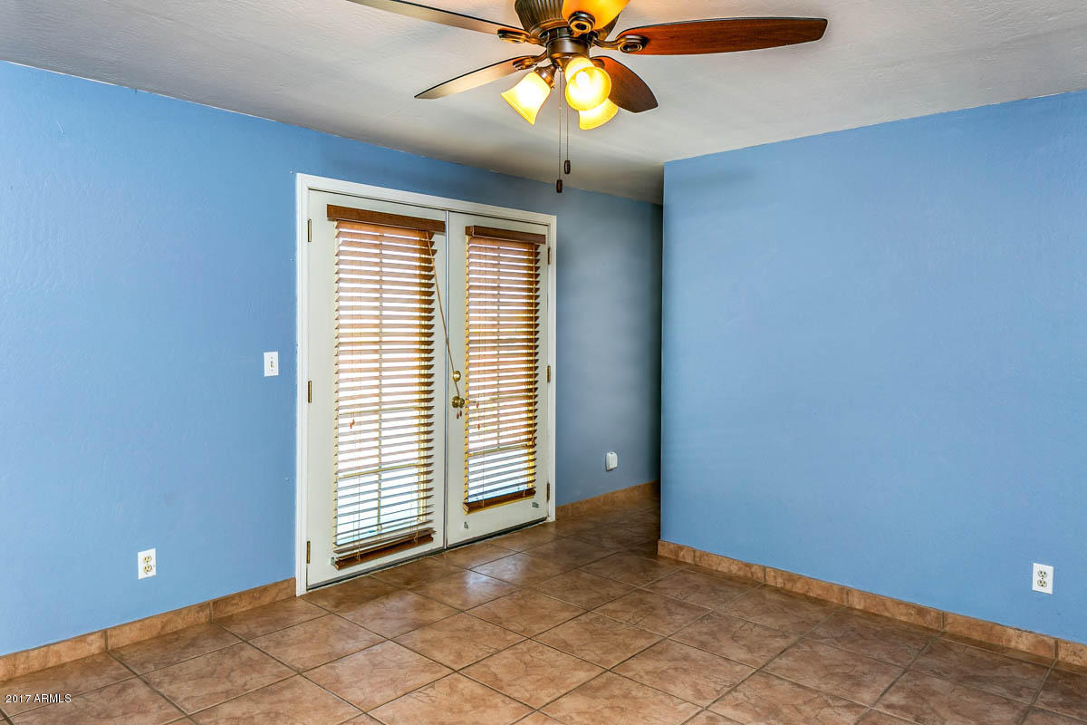 41568 North Rattlesnake Road San Tan Valley, AZ 85140 - Photo 14 of 32 a view of an empty room with window and chandelier fan