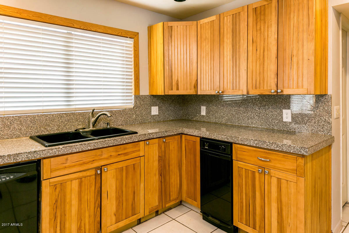41568 North Rattlesnake Road San Tan Valley, AZ 85140 - Photo 3 of 32 a kitchen with stainless steel appliances granite countertop a sink and a window