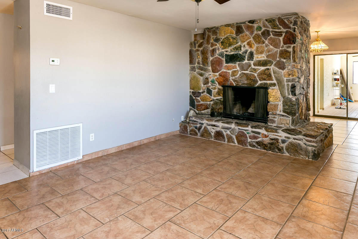 41568 North Rattlesnake Road San Tan Valley, AZ 85140 - Photo 6 of 32 a view of a livingroom with a fireplace and a window