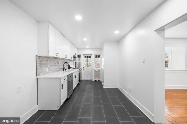 a kitchen with a sink stove and cabinets