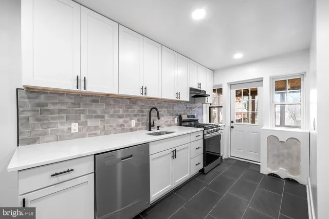 a kitchen with a sink stove and cabinets
