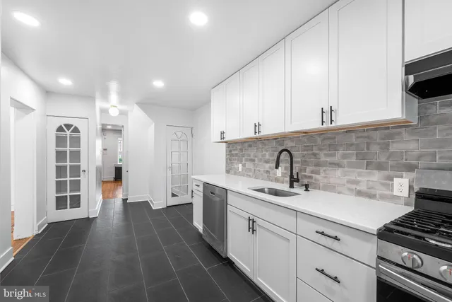 a view of a big dining room with furniture large windows wooden floor and garden view