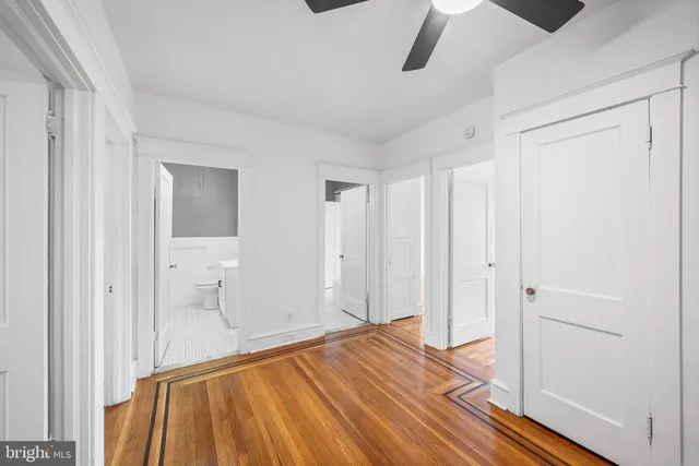 a view of empty room with wooden floor