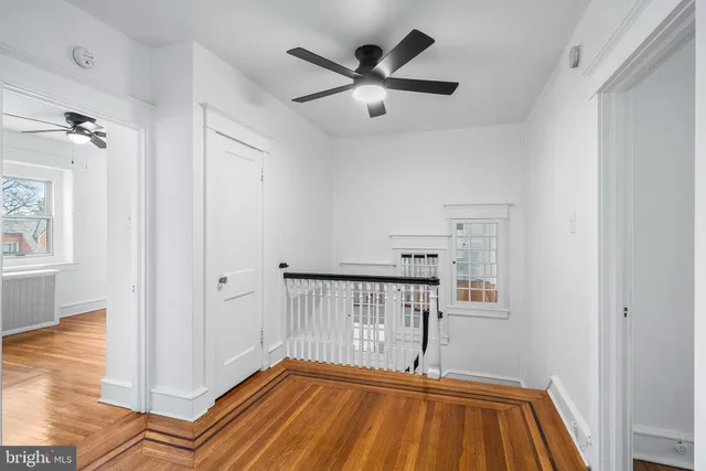 a view of a room with a window and wooden floor