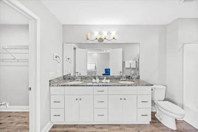 an aerial view of a city with lots of residential buildings ocean and mountain view in back