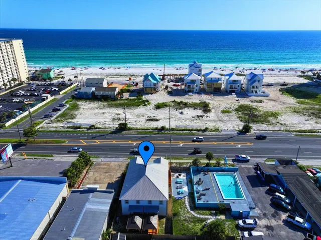 a kitchen with stainless steel appliances kitchen island granite countertop a dining table chairs and white cabinets