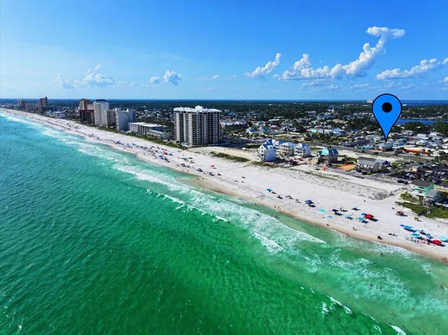 a kitchen with stainless steel appliances granite countertop a stove top oven a sink dishwasher a dining table and chairs with wooden floor